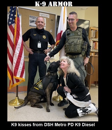 K9 kisses from State Hospital Metro PD K9 Diesel for K9 Armor cofounder Suzanne at ceremony with Chief Rivera and Officer Bell