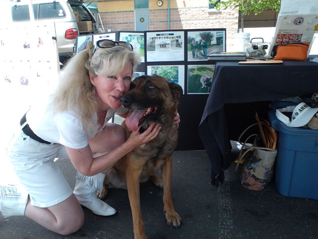Dos Palos PD K9 Scar pauses for hugs from Suzanne Saunders, K-9 Armor Co-Founder.