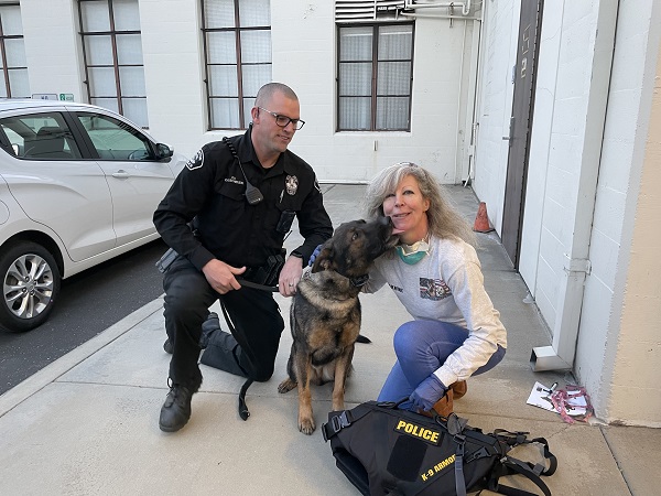 Kisses from Fullerton PD K9 Rotar for K9 Armor cofounder Suzanne and Officer Kalscheuer