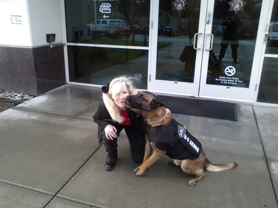 Suzanne Saunders of K-9 Armor receives K9 kisses from Richmond PD K9 Bosco